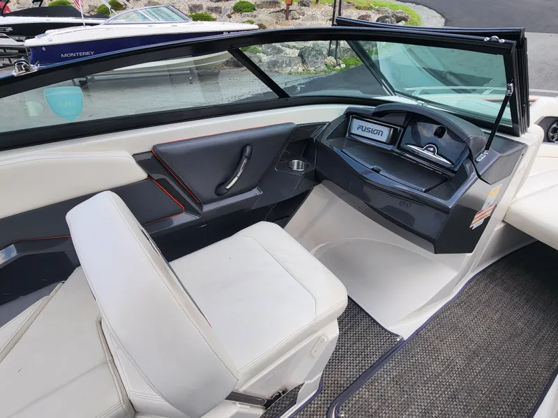 Slide: The Image of Interior of a 2014 Monterey 234 Super Sport boat with white seating and Fusion stereo system. - 16