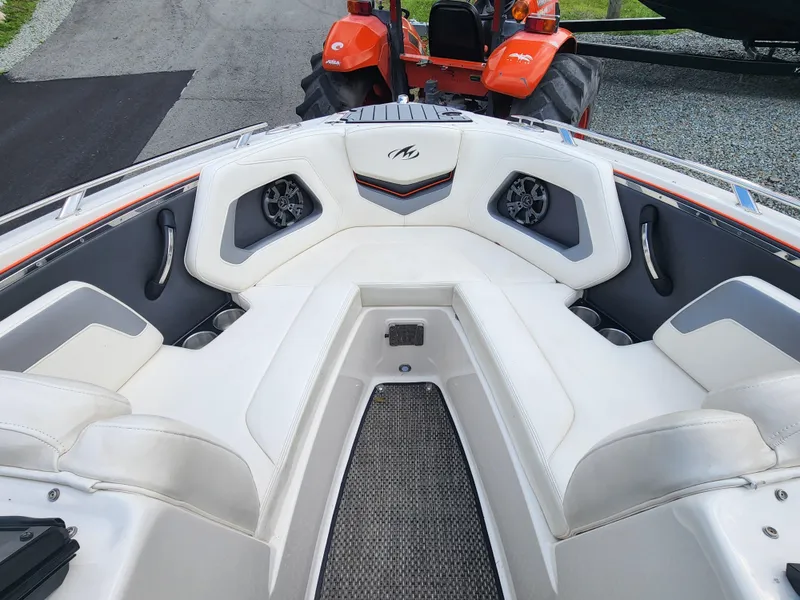 Slide: The Image of 2014 Monterey 234 Super Sport boat interior with white seating and speakers. - 17