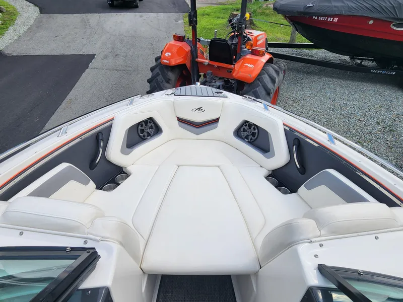 Slide: The Image of 2014 Monterey 234 Super Sport boat with white interior and orange tractor in background. - 18