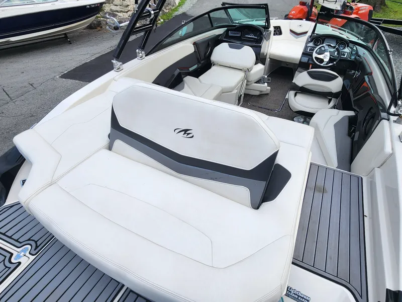 Slide: The Image of 2014 Monterey 234 Super Sport boat interior with white seating and modern dashboard. - 7
