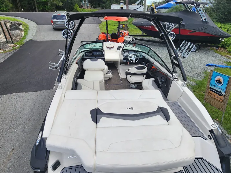 Slide: The Image of 2014 Monterey 234 Super Sport boat interior with seating and dashboard. - 8