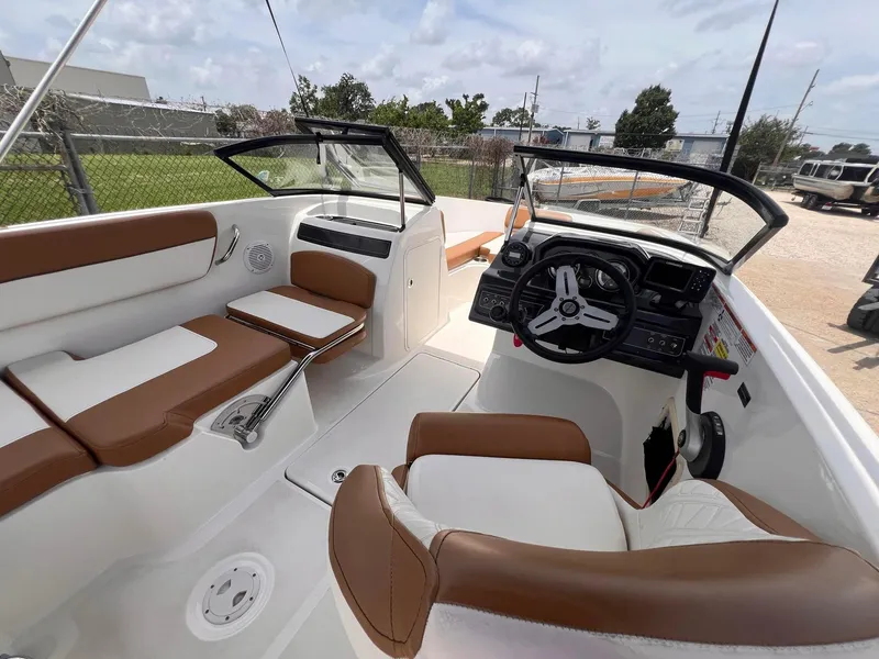 Slide: The Image of 2021 Bayliner VR5 Bowrider I/O interior with brown and white seating. - 11
