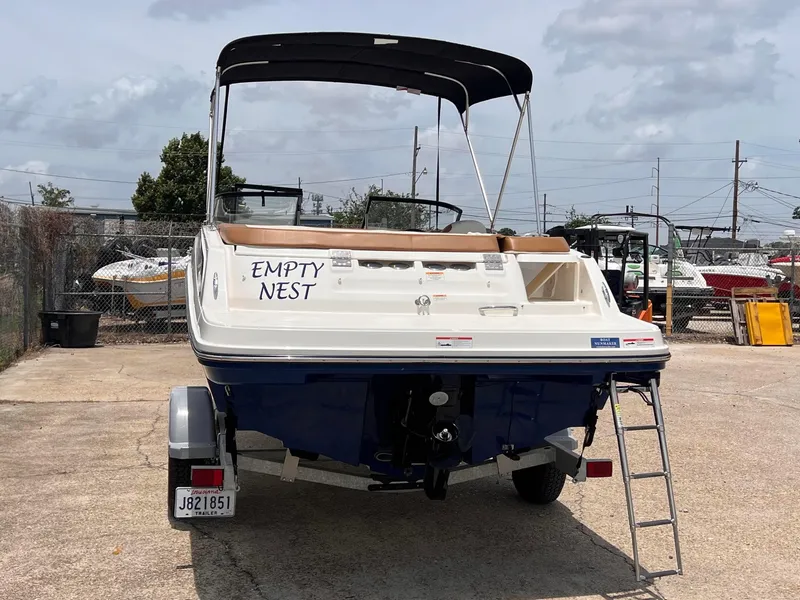 Slide: The Image of 2021 Bayliner VR5 Bowrider I/O boat with Empty Nest text on the stern. - 4