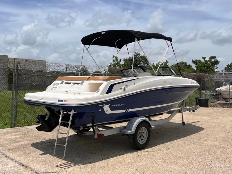 Slide: The Image of 2021 Bayliner VR5 Bowrider I/O boat on trailer with bimini top. - 5