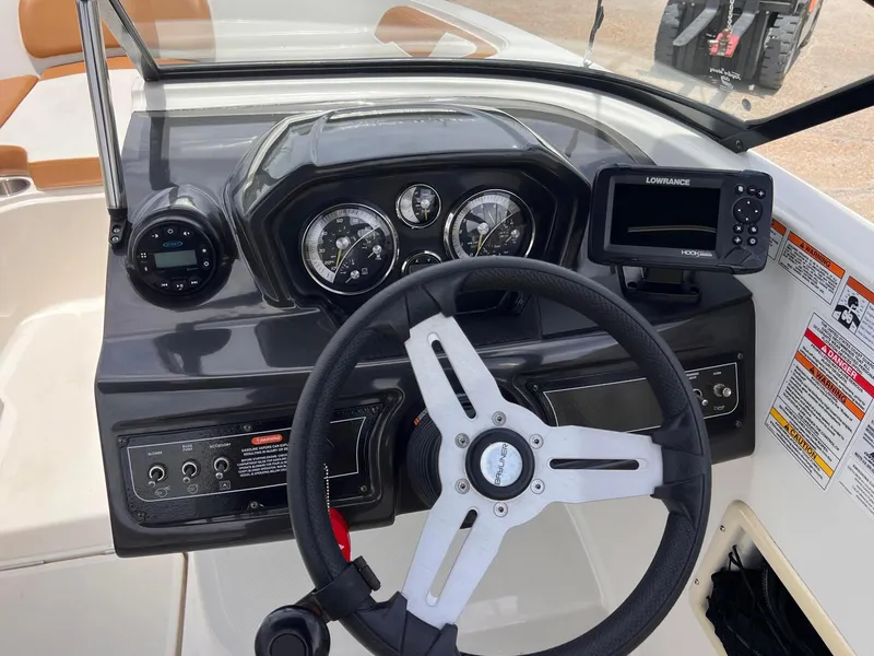 Slide: The Image of 2021 Bayliner VR5 Bowrider I/O dashboard with steering wheel and navigation instruments. - 6