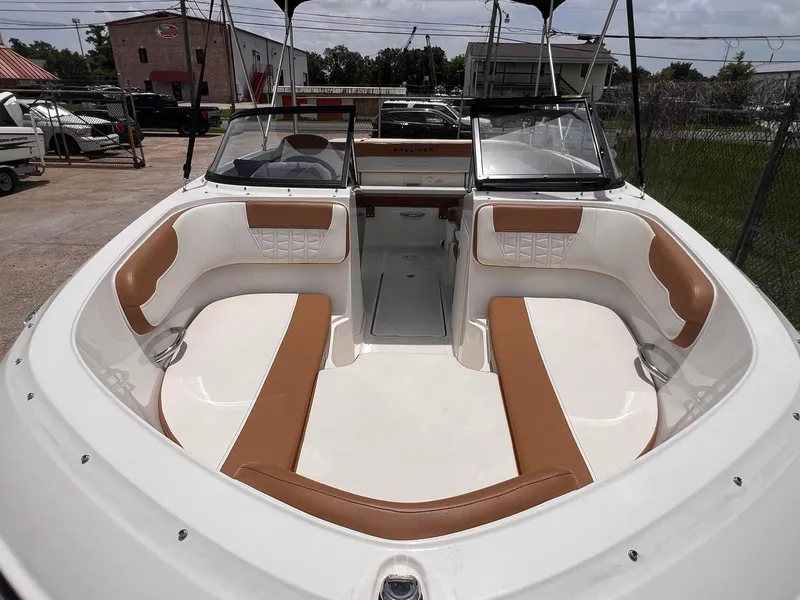 Slide: The Image of 2021 Bayliner VR5 Bowrider I/O with tan and white seating, docked outdoors. - 7