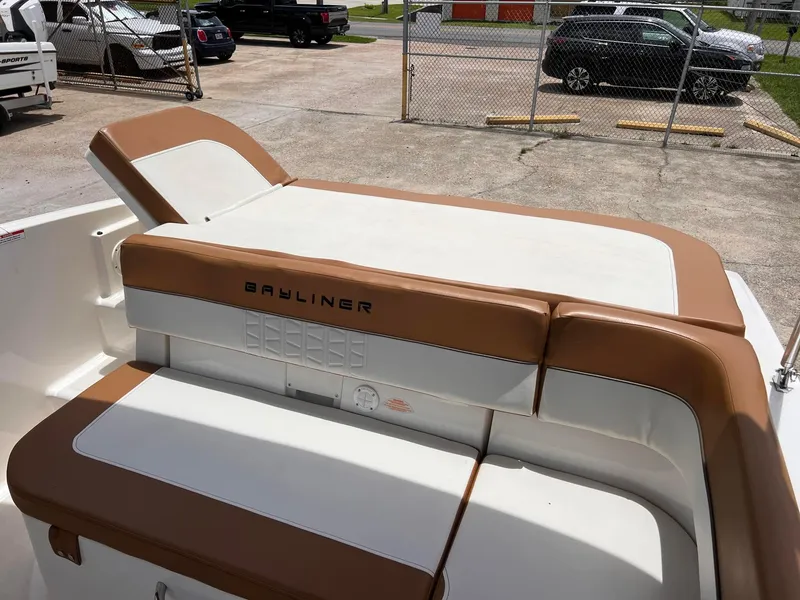 Slide: The Image of 2021 Bayliner VR5 Bowrider I/O boat with tan and white seating. - 9