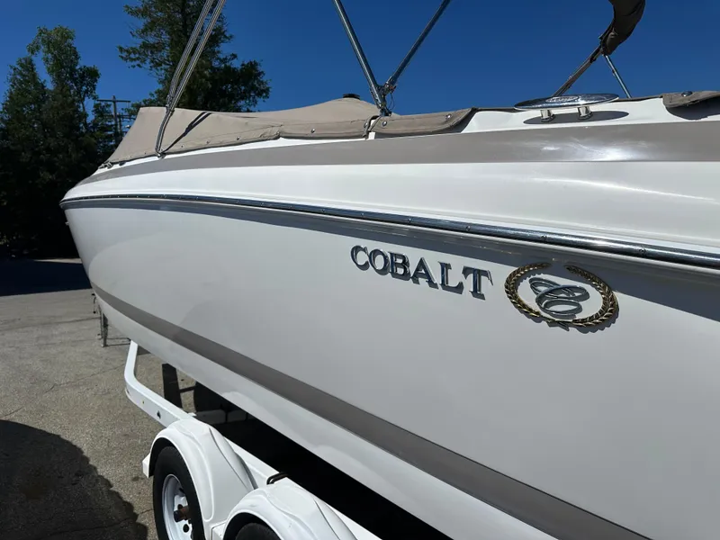Slide: The Image of 2003 Cobalt 262 boat on trailer, side view with logo visible. - 1