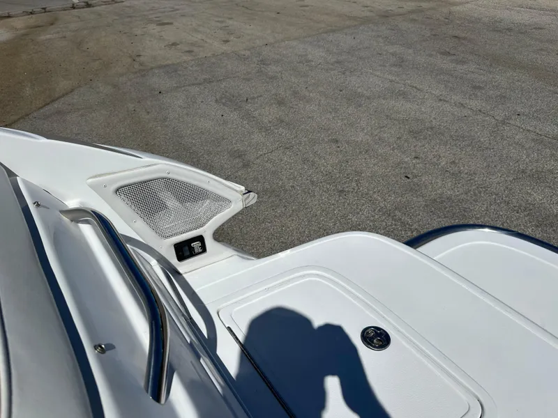 Slide: The Image of 2003 Cobalt 262 boat deck with storage compartment and speaker. - 12