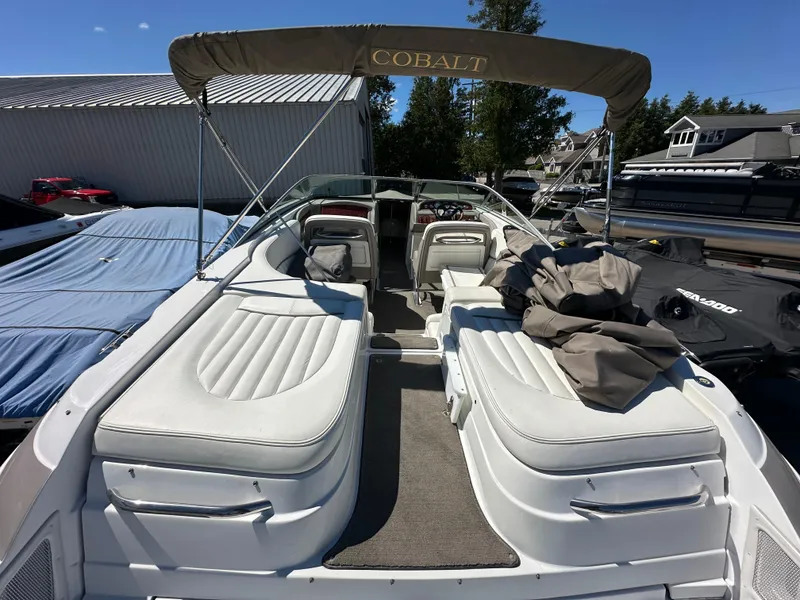 Slide: The Image of 2003 Cobalt 262 boat with white interior and canopy, docked at marina. - 15