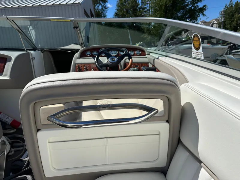 Slide: The Image of 2003 Cobalt 262 boat interior with steering wheel and dashboard. - 23
