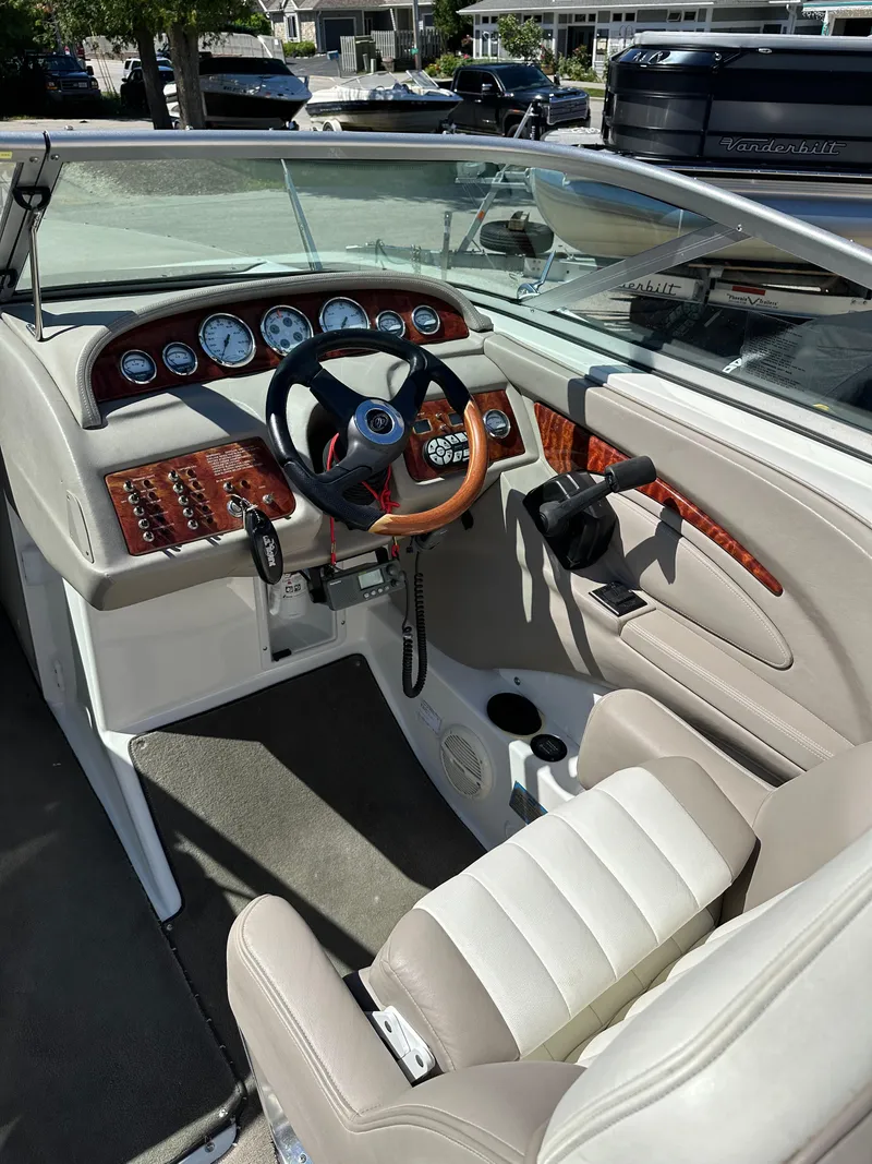 Slide: The Image of 2003 Cobalt 262 boat cockpit with steering wheel and control panel. - 24