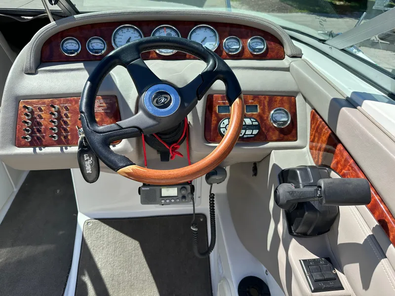 Slide: The Image of 2003 Cobalt 262 boat dashboard with steering wheel and control panel. - 25