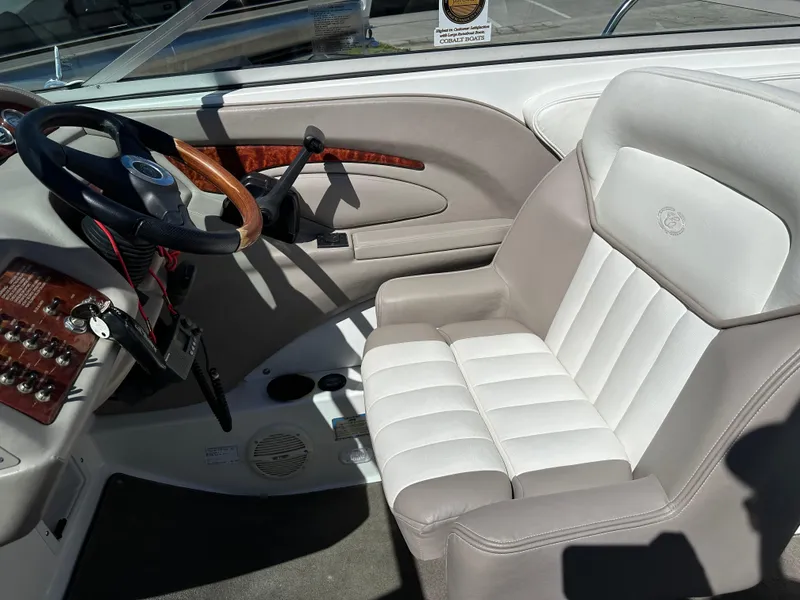 Slide: The Image of 2003 Cobalt 262 boat interior with steering wheel and captain's seat. - 26