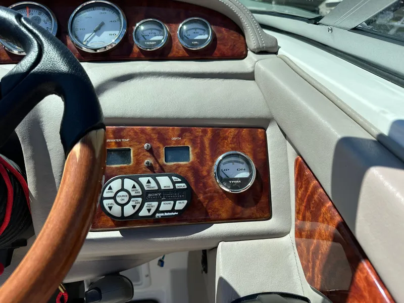 Slide: The Image of Dashboard of a 2003 Cobalt 262 boat with wood trim and gauges. - 29