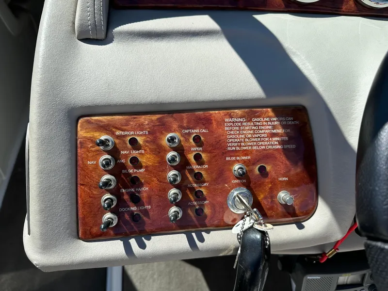 Slide: The Image of Control panel of a 2003 Cobalt 262 boat with various switches and warning labels. - 30