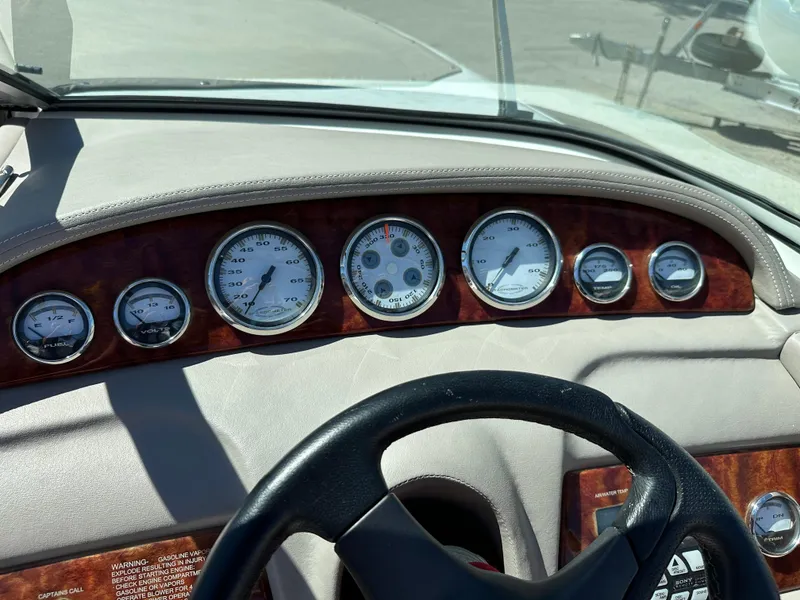 Slide: The Image of Dashboard of a 2003 Cobalt 262 boat with gauges and steering wheel. - 31