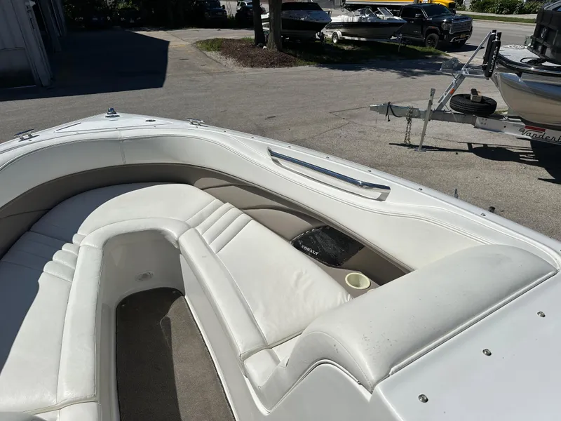 Slide: The Image of 2003 Cobalt 262 boat with white leather seating in the bow area. - 33