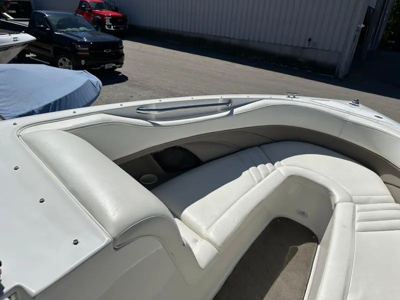Slide: The Image of 2003 Cobalt 262 boat with white leather seating in a parking lot. - 34