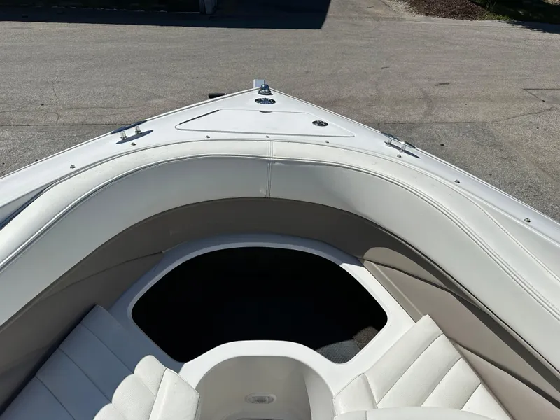 Slide: The Image of 2003 Cobalt 262 boat bow seating area with white upholstery. - 36
