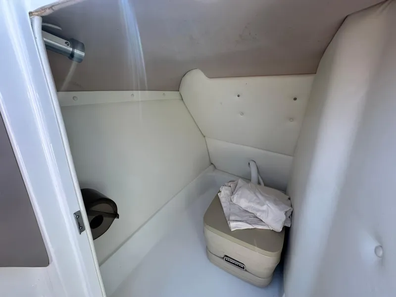 Slide: The Image of Interior cabin of a 2003 Cobalt 262 boat with storage and seating. - 42