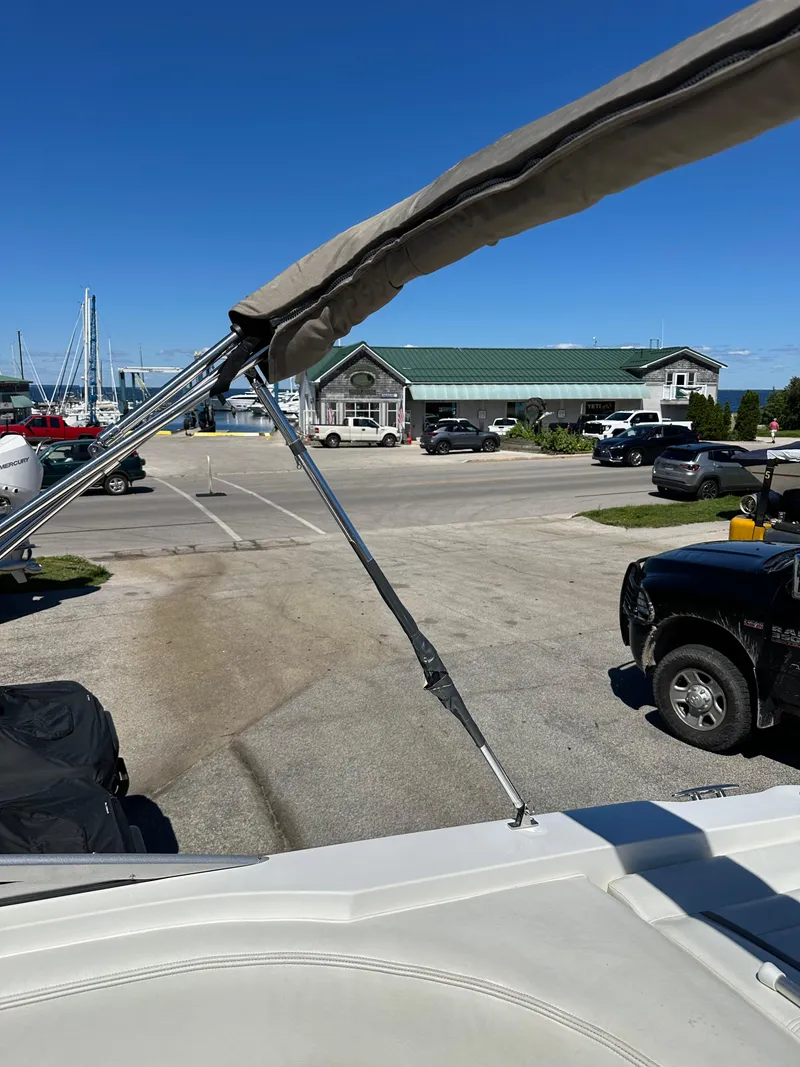 Slide: The Image of 2003 Cobalt 262 boat docked at a marina with a view of the parking lot. - 45