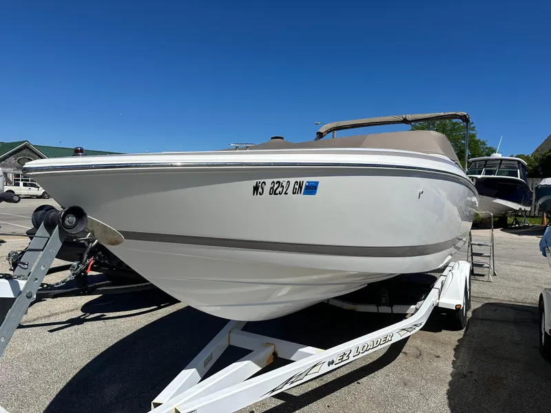 Slide: The Image of 2003 Cobalt 262 boat on a trailer in a parking lot. - 9