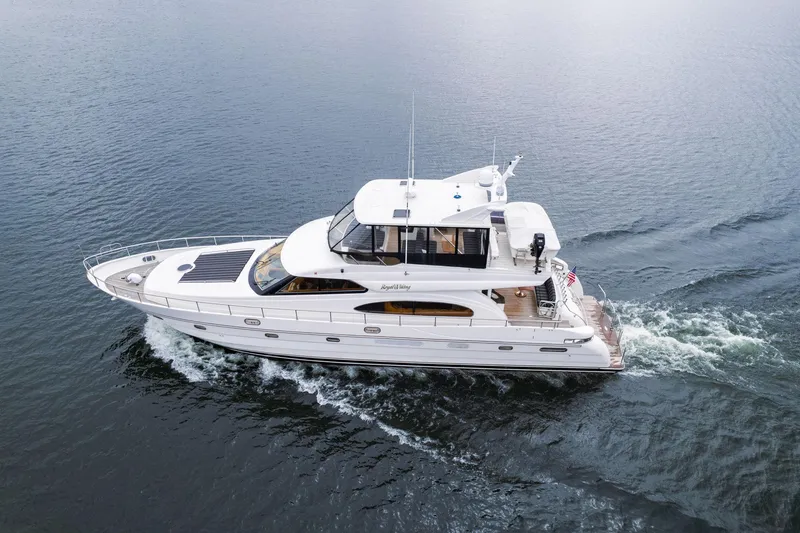 The Image of 1999 Vitech 68' Pilothouse yacht cruising on open water. - 1