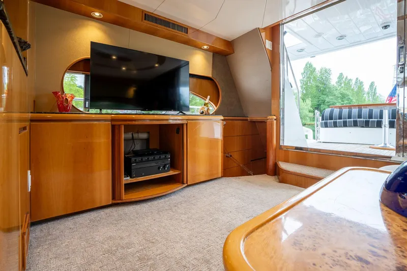 Slide: The Image of Luxurious interior of 1999 Vitech 68' Pilothouse yacht with TV and elegant wood finish. - 12