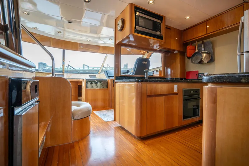 Slide: The Image of Luxurious interior of 1999 Vitech 68' Pilothouse yacht with modern kitchen amenities. - 13