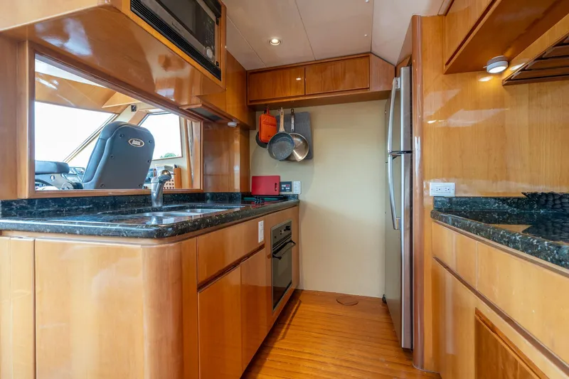 Slide: The Image of Luxurious kitchen interior of 1999 Vitech 68' Pilothouse yacht with modern appliances. - 14