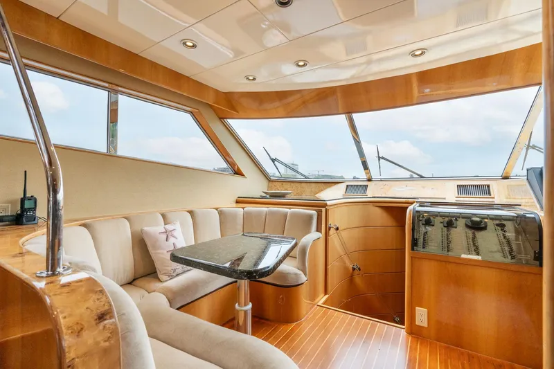 Slide: The Image of Luxurious interior of 1999 Vitech 68' Pilothouse yacht with plush seating and elegant wood finishes. - 16