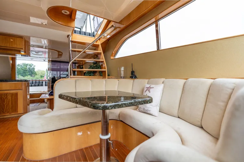 Slide: The Image of Luxurious interior of 1999 Vitech 68' Pilothouse yacht with elegant seating and staircase. - 17