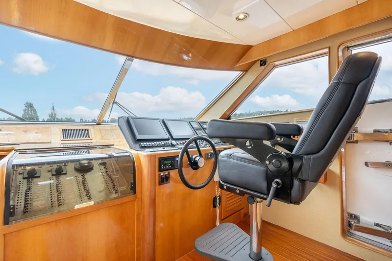 Slide: The Image of Pilothouse interior of 1999 Vitech 68' yacht, featuring modern controls and captain's chair. - 18
