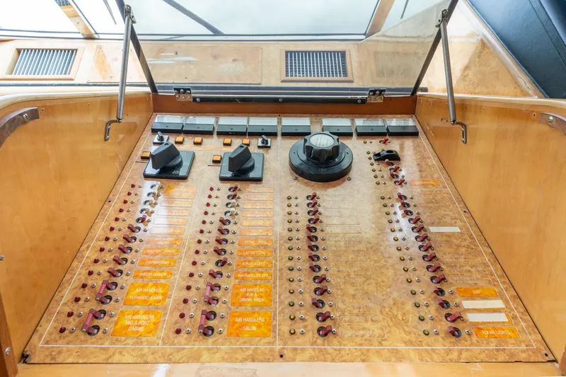 Slide: The Image of Control panel of 1999 Vitech 68' Pilothouse yacht, featuring switches and dials. - 19