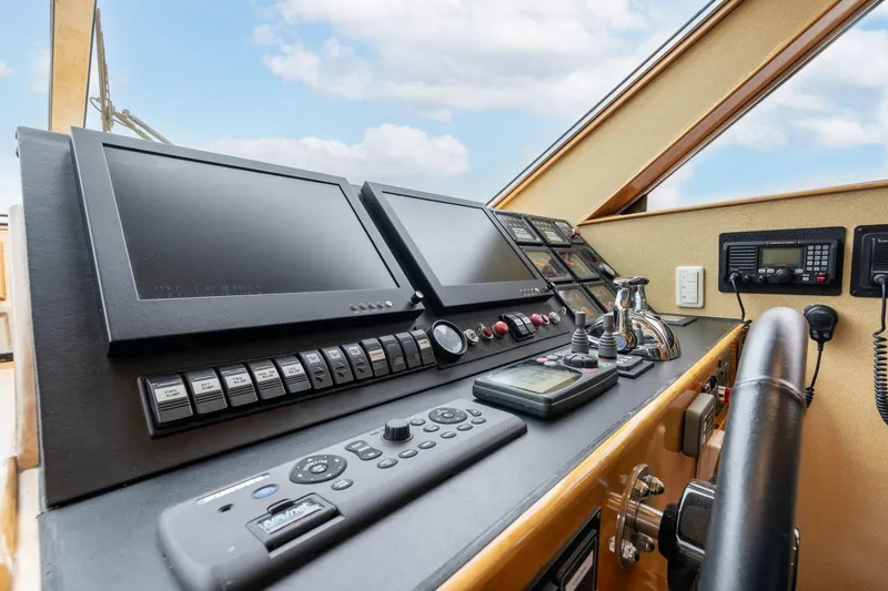 Slide: The Image of Pilothouse controls of 1999 Vitech 68' yacht with navigation screens and instruments. - 20
