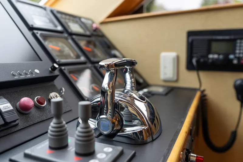 Slide: The Image of Control panel of a 1999 Vitech 68' Pilothouse yacht, featuring navigation instruments and controls. - 24