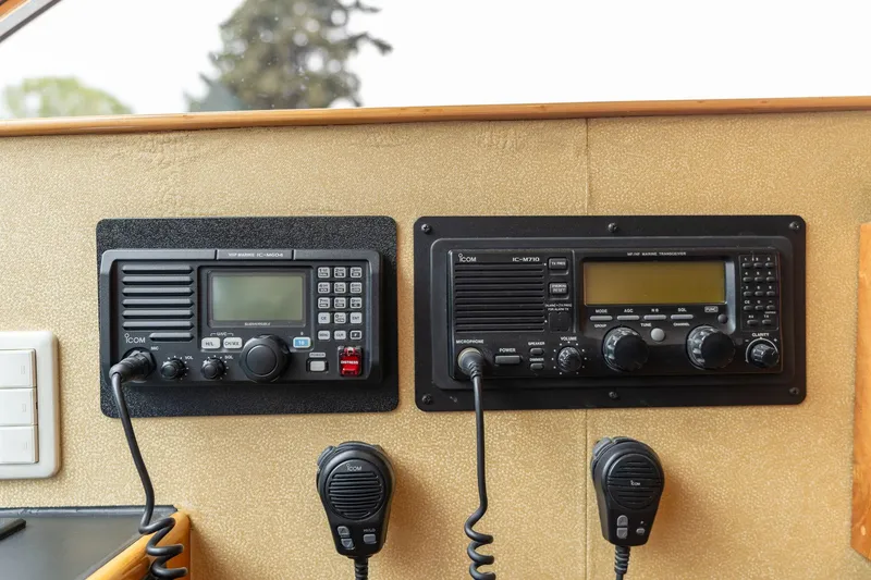 Slide: The Image of Control panel of 1999 Vitech 68' Pilothouse with communication radios and microphones. - 27