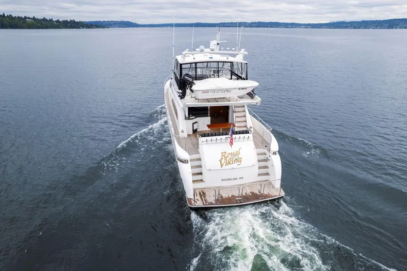 Slide: The Image of 1999 Vitech 68' Pilothouse yacht cruising on open water, rear view. - 3