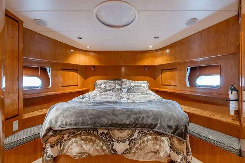 Slide: The Image of Luxurious bedroom interior of 1999 Vitech 68' Pilothouse yacht with wood paneling and cozy bedding. - 34