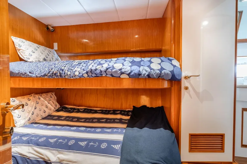 Slide: The Image of Bunk beds in 1999 Vitech 68' Pilothouse yacht cabin with nautical-themed bedding. - 37