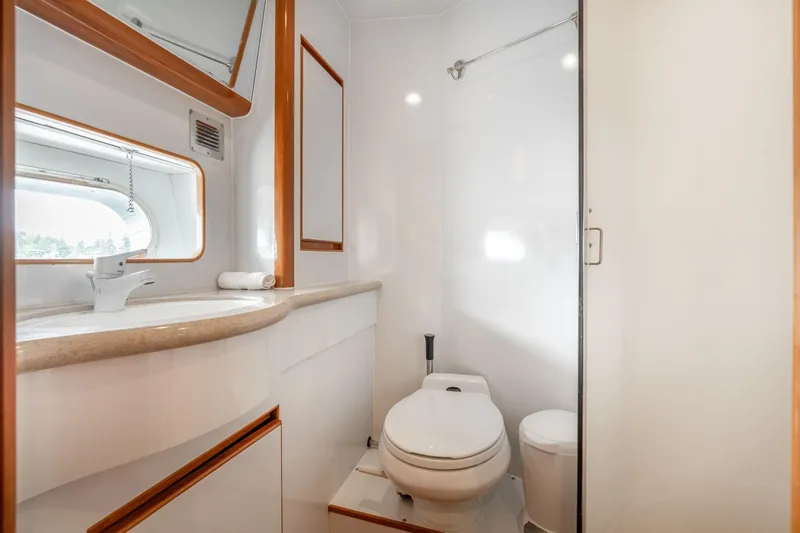 Slide: The Image of Bathroom interior of 1999 Vitech 68' Pilothouse yacht, featuring modern fixtures and sleek design. - 40