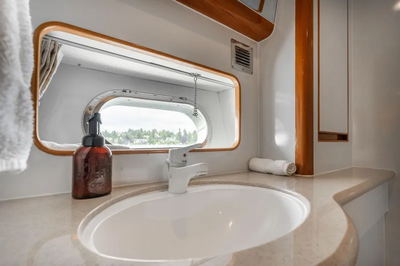 Slide: The Image of Luxurious bathroom interior of 1999 Vitech 68' Pilothouse yacht with sink and window view. - 41