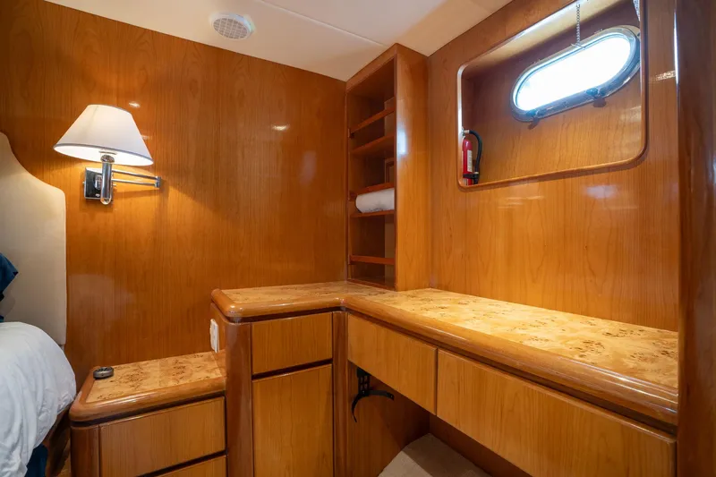 Slide: The Image of Luxurious wooden interior of 1999 Vitech 68' Pilothouse yacht cabin with desk and shelves. - 45