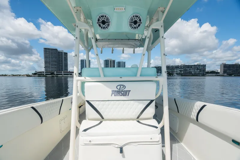 Slide: The Image of 2000 Pursuit 2870 Center Console boat on calm water with city skyline. - 11