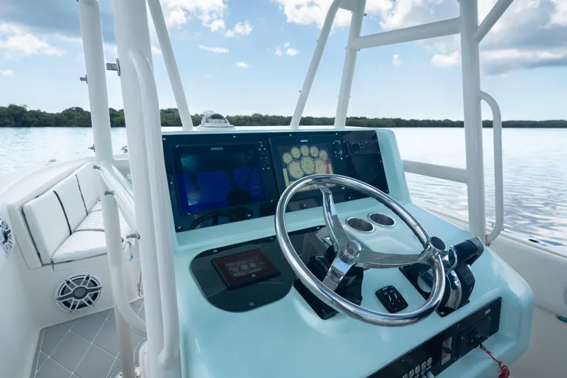 Slide: The Image of 2000 Pursuit 2870 Center Console boat helm with modern navigation equipment. - 14