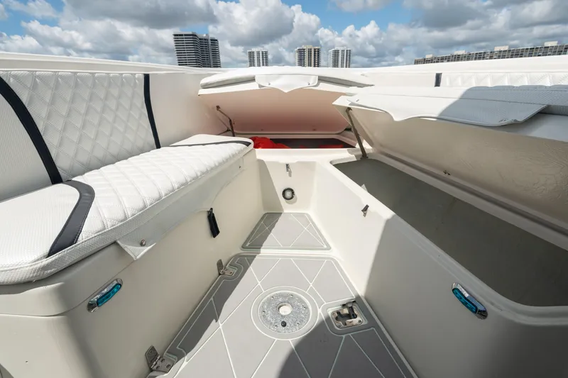 Slide: The Image of 2000 Pursuit 2870 Center Console boat interior with storage compartments and cushioned seating. - 20