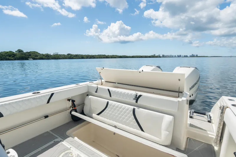 Slide: The Image of 2000 Pursuit 2870 Center Console boat interior with open storage, on calm water. - 23