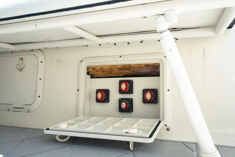 Slide: The Image of 2000 Pursuit 2870 Center Console battery switches and storage compartment. - 25