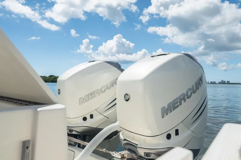 Slide: The Image of Twin Mercury outboard engines on a 2000 Pursuit 2870 Center Console boat. - 27